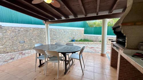 a table and chairs on a patio with a fireplace at Golfinho - Private Pool - 10 Guests - Albufeira in Albufeira