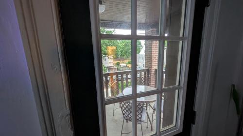 an open window with a view of a balcony at Rooftop GreeneHouse Suite in Philadelphia