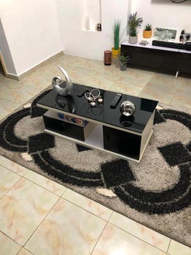 a living room with a table on a rug at 3 Bedroom Bungalow at Heliu Estate in Enugu