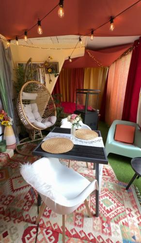 a living room with a table and chairs at LAmOuR in Oudon