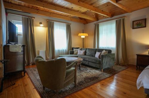 a living room with a couch and a table at Nomad Hotel & Glamping in Noszvaj