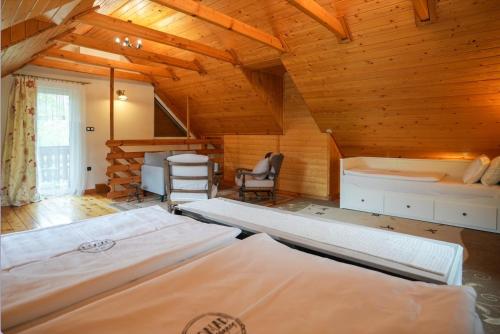 a bedroom with two beds in a wooden cabin at Nomad Hotel & Glamping in Noszvaj