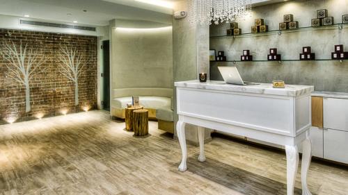a white piano in a room with a couch at The O Hotel, Trademark Collection by Wyndham in Los Angeles