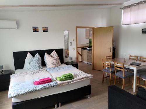 a bedroom with a bed and a dining room at Nette Wohnung In Großsteinberg Mit Grill Und Terrasse in Pomssen
