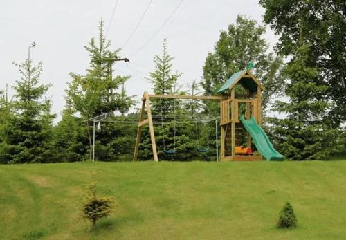 a playground in a field with a slide at Fewo Erzgebirge in Dorfchemnitz