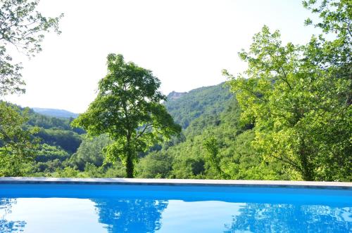a swimming pool with a view of the mountains at Stone House Kotli in Kotli