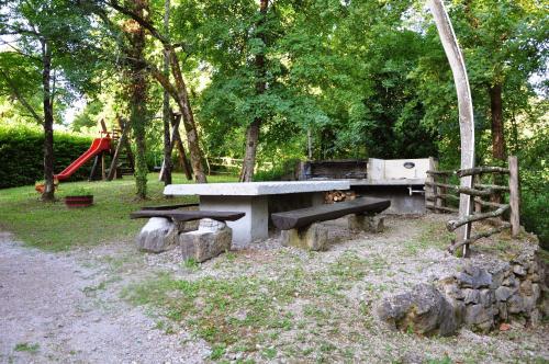 a park with a picnic table and a playground at Stone House Kotli in Kotli