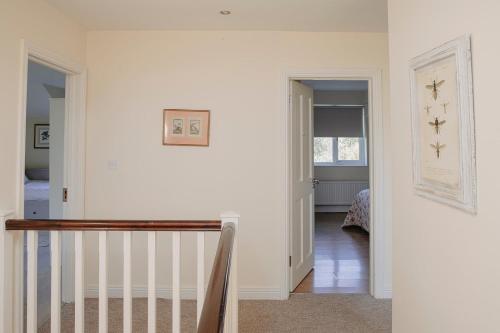 a hallway with a stairway leading to a bedroom at The River House in Slane