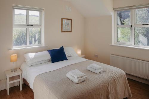 a bedroom with a bed with two towels on it at The River House in Slane