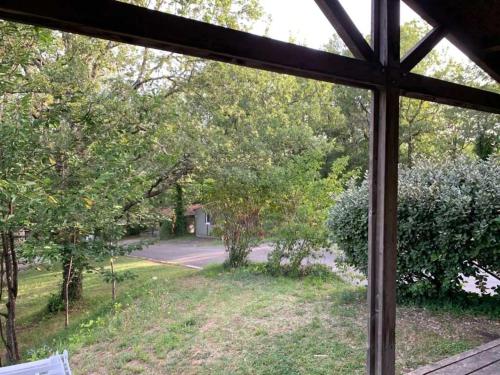 a window view of a yard from a house at Chalet 3 étoiles - Piscine - eebbib in Monclar-de-Quercy
