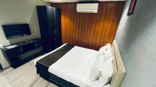 a hotel room with a bed and a television at Gulf Hotel Mumbai- The Boutique Hotel Colaba Mumbai in Mumbai