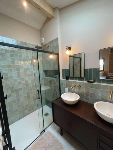 a bathroom with two sinks and a glass shower at Magnifique chambre pour une pause détente à Ahetze in Ahetze