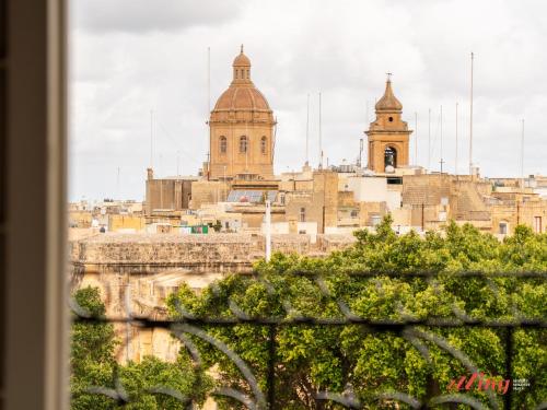 a view of the city from a window at Yolanda Boutique Suites by Zzzing in Birgu