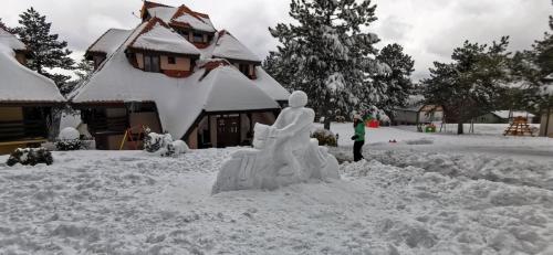 a snow sculpture in front of a house at Pastirica in Divčibare