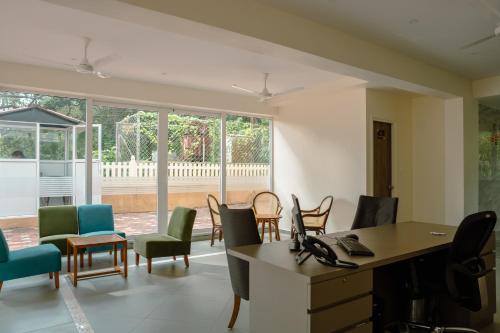 an office with chairs and a desk in a room at Nanu Beach Resort & Spa in Betalbatim