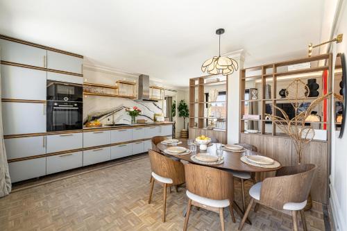 une cuisine avec une table et des chaises dans une pièce dans l'établissement Luxurious penthouse, 2 bedroom suites, 3 spacious terraces, gorgeous views of mountains and sea,, à Nice