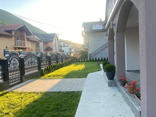 a house with a fence and a grass yard at Villa Ljiljan in Sarajevo