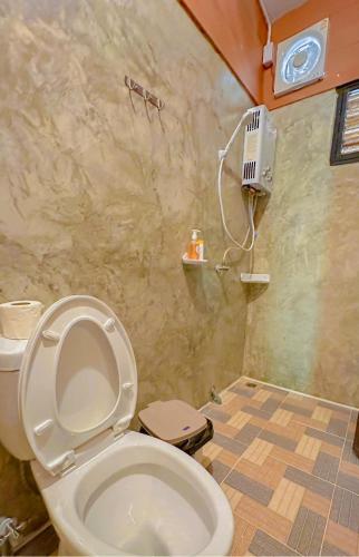 a bathroom with a toilet and a shower at บ้านมานอนดอย - Manondoi โฮมสเตย์เชียงดาว in Ban Pang Klang