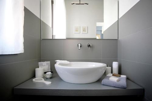 a bathroom with a large white tub and a mirror at B&B Trovailtempo in Milan