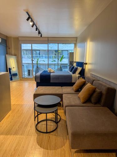 a living room with a couch and a bed at Foster Studio - Nicaragua in Buenos Aires