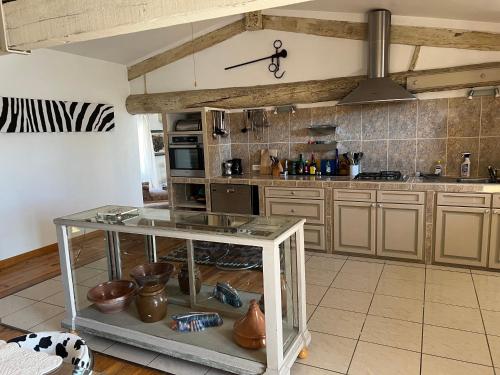 - une cuisine avec une table en verre dans une pièce dans l'établissement Chez Christel, à Apt