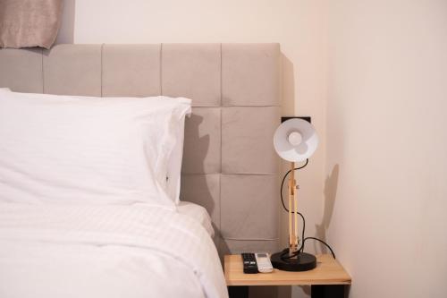 a bedroom with a bed and a lamp on a table at Mani view luxury house in Agios Nikolaos