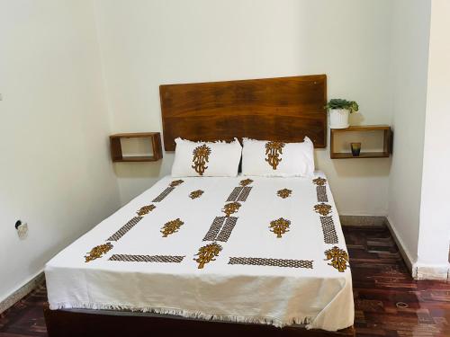 a bedroom with a large bed with gold decorations on it at Bete Selam in Bahir Dar