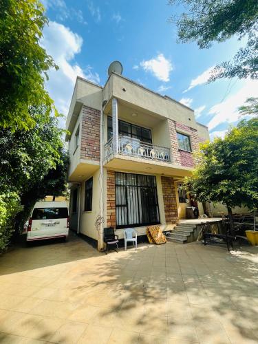 a house with a car parked in front of it at Bete Selam in Bahir Dar