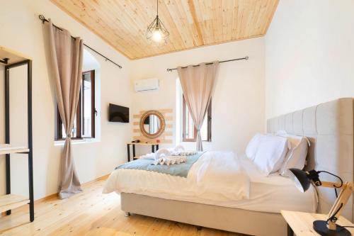 a bedroom with a bed with a wooden ceiling at Mani view luxury house in Agios Nikolaos