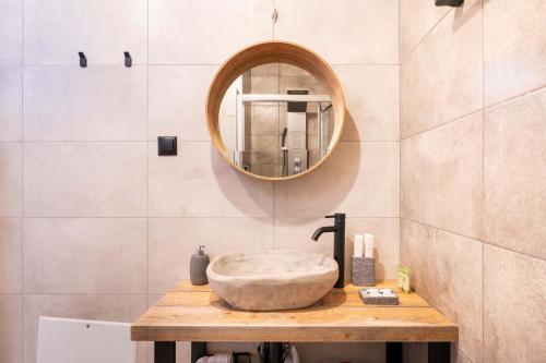 a bathroom with a stone sink and a mirror at Mani view luxury house in Agios Nikolaos
