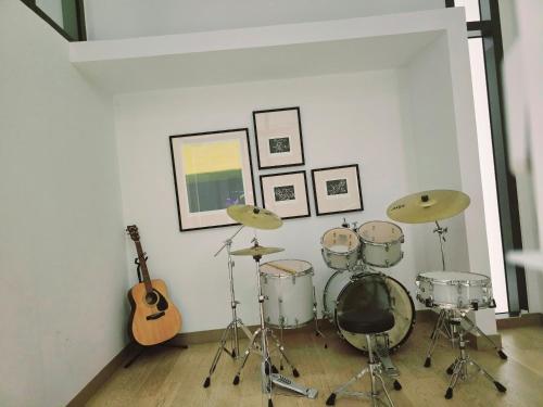 a room with a drum set and a guitar at LUCENTIA RESIDENCE By LALAPORT in Kuala Lumpur