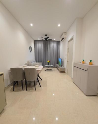 a living room with a table and chairs and a kitchen at LUCENTIA RESIDENCE By LALAPORT in Kuala Lumpur