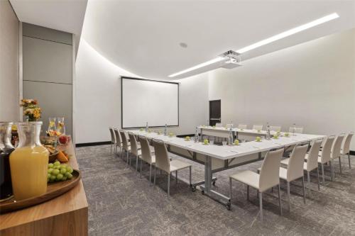 a large conference room with a long table and chairs at NH Collection Monterrey San Pedro in Monterrey