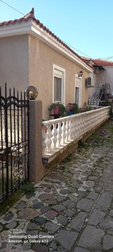 a fence in front of a house with a stone walkway at Maria,s house in Petra
