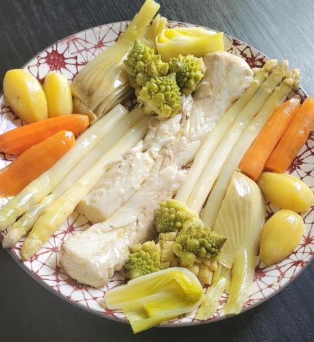 a plate of meat and vegetables on a table at Agapanthe & Salicorne - Maison d'hôtes, Chambres d'hôtes- in Pluduno
