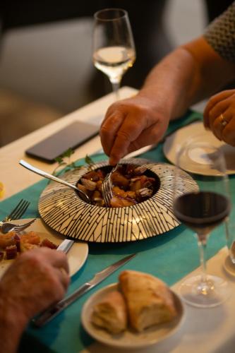 a person eating food on a table with a plate of food at Hotel Carboneras Cabo de Gata Spa in Carboneras