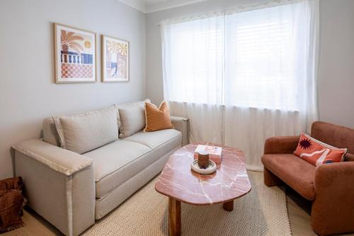 a living room with a couch and a coffee table at The Holkham Uno - One Bed Apartment Fairy Bower in Sydney