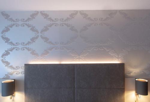 a room with two candles and a wall at Hotel Alte Post in Krefeld