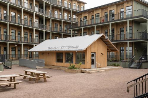 a building with benches in front of a building at Waterfront Cabins in Gothenburg