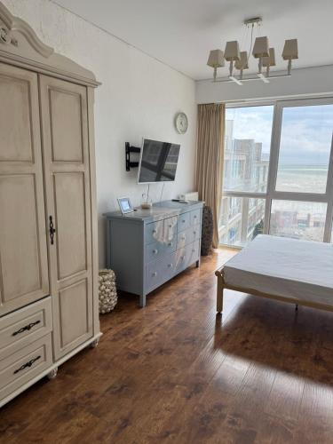 a bedroom with a bed and a dresser and a window at Отдых у моря Одесса in Kryzhanivka
