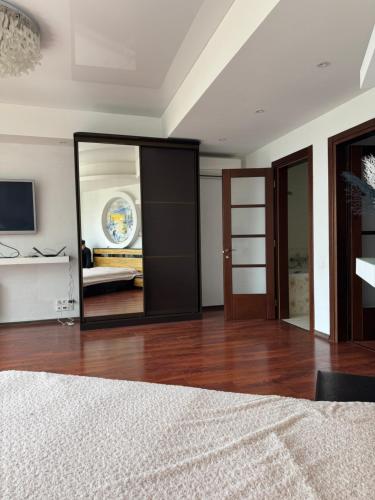 a bedroom with a mirror and a bed at Отдых у моря Одесса in Kryzhanivka