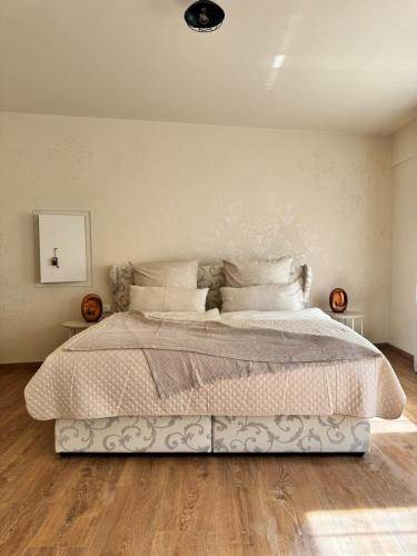 a bedroom with a large bed with white sheets and pillows at Factory Loft Eifel in Leimbach
