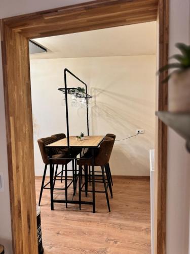 a dining room with a table and chairs at Factory Loft Eifel in Leimbach