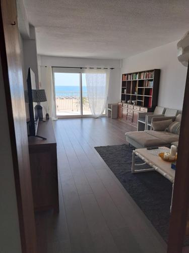 a living room with a view of the ocean at APARTAMENTO SOL Y MAR Primera Linea in Playa de Gandia