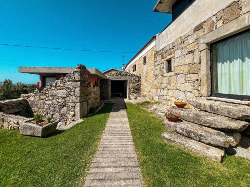 a stone building with a pathway in front of it at Casas da Fonte in Viana do Castelo