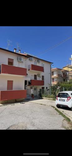 a white car parked in front of a building at Carini Sant Anna in Carini