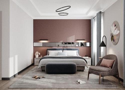 a bedroom with a large bed and a chair at Достык Люкс in Kostanay