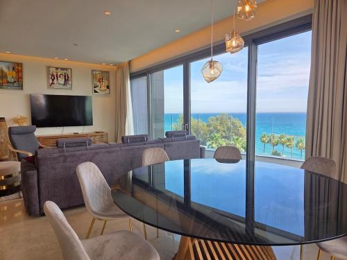a living room with a glass table and a couch at Luxury Seaview Escape 3bd in Limassol Skyscraper in Limassol