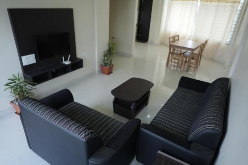 a living room with a couch and a table at Kalgadde in Chikmagalūr