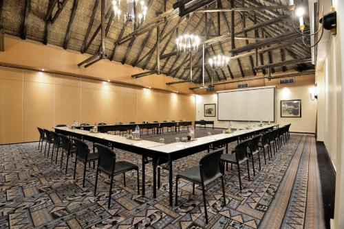 a large conference room with a long table and chairs at Kwa Maritane Lodge in Ledig